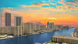 A waterfront cityscape with high-rise buildings, a marina, and a sunset. - Spectacular Apartment Bliss, Pool & Gym (Hallandale Beach)