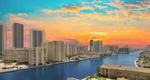 A waterfront cityscape with high-rise buildings, a marina, and a sunset. - Spectacular Apartment Bliss, Pool & Gym (Hallandale Beach)