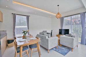 Deluxe Villa | Living area | 24-inch flat-screen TV with cable channels - Bernard Villa by Betterplace (Ungasan)