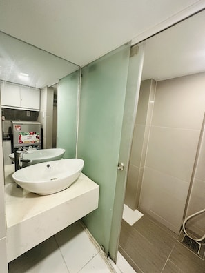 A bathroom with two sinks, a mirror, and a shower area. - Huyen Apartment (Ho Chi Minh City)