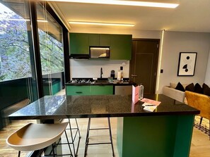 Enjoy casual dining or entertaining in this kitchen with a bar area and large window offering a view.