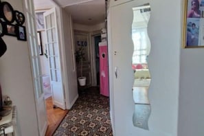 Enter a simple, functional space with a patterned floor, a door with a decorative glass panel, and a small window.