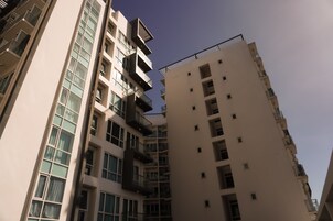 A multi-story residential building with balconies and large windows.