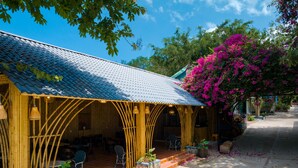 A bamboo structure with a tiled roof and outdoor seating area. - Phuc Thang Resort  (Phu Quoc)