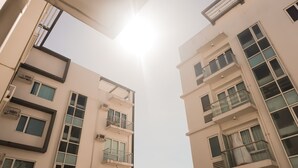 A multi-story building with balconies and air conditioning units. - Comfy Studio UnitL OneMadison35 (Iloilo)