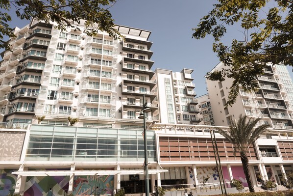 A multi-story residential building with balconies, large windows, and a modern architectural design. - Comfy Studio UnitL OneMadison35 (Iloilo)
