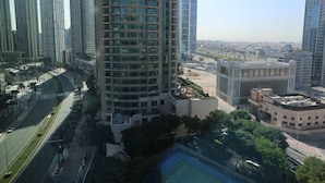 A high-rise building with a modern design, surrounded by other tall buildings.