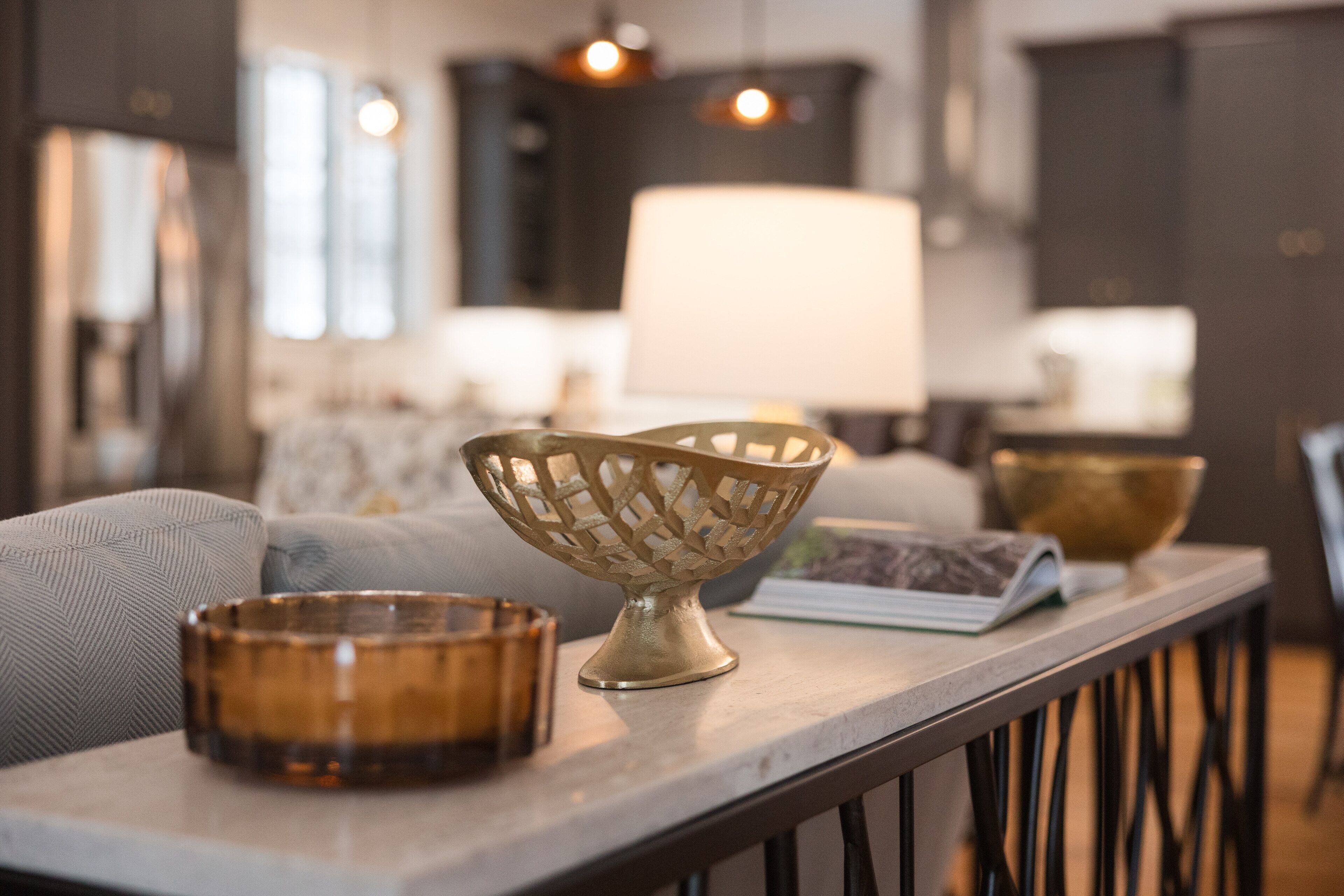 A modern living room with a sofa, a coffee table, and decorative bowls.