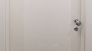 A white door with a sign reading "101" and a keyhole.