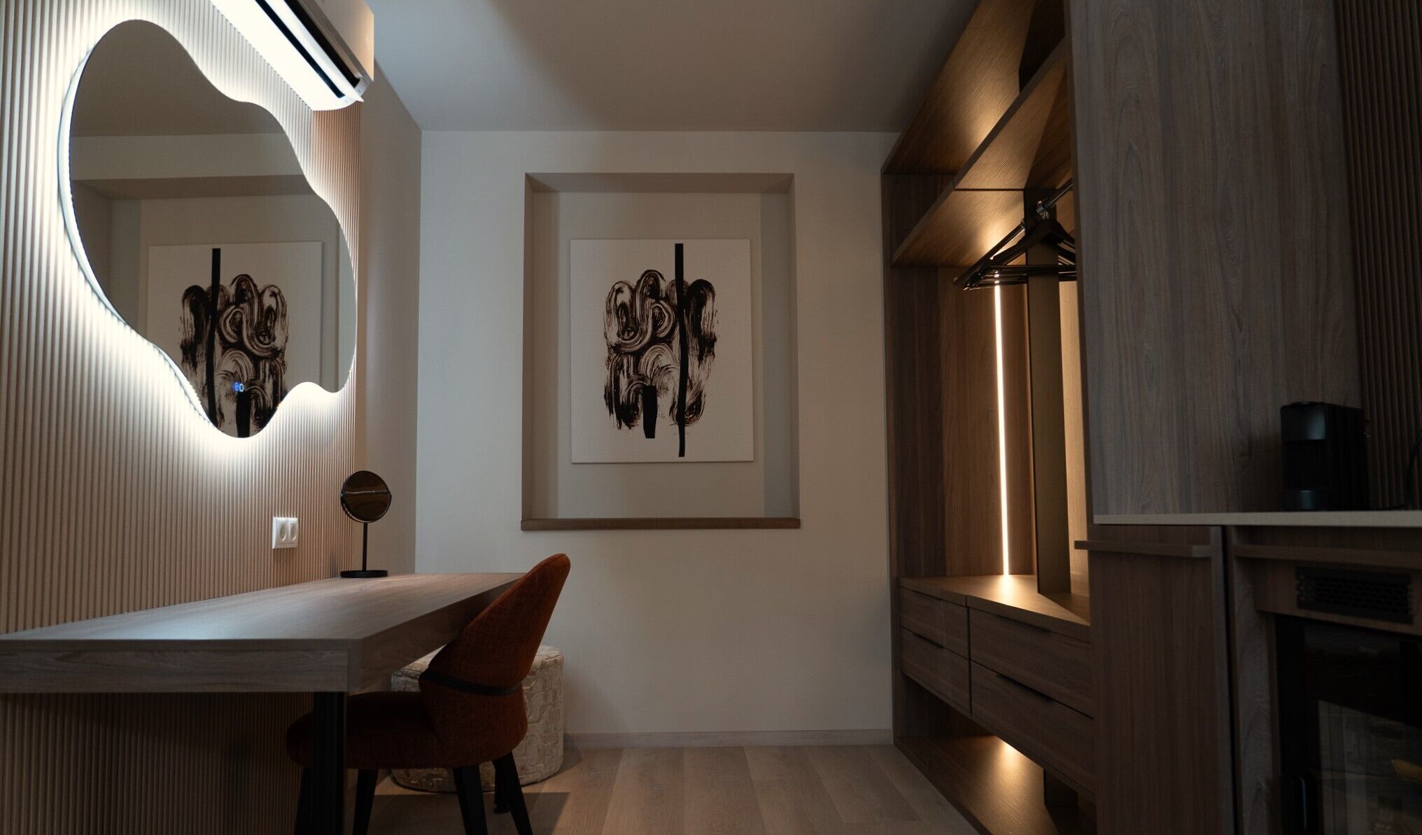 A modern kitchen with wooden cabinetry, a built-in oven, and a countertop.