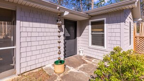 A house with a grey exterior, a front door, and a window. - Harry's Handicap Accessible Tea House (Charlotte)