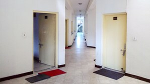 A long, narrow hallway with doors on both sides, numbered 105 and 109, leading to rooms. - Rahi Motel (Haridwar)