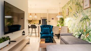 Superior Apartment, Patio, Sea View | Living area | 55-inch Smart TV with digital channels