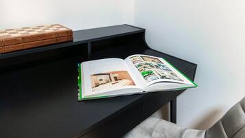 A book open on a black desk with a checkered box on top.