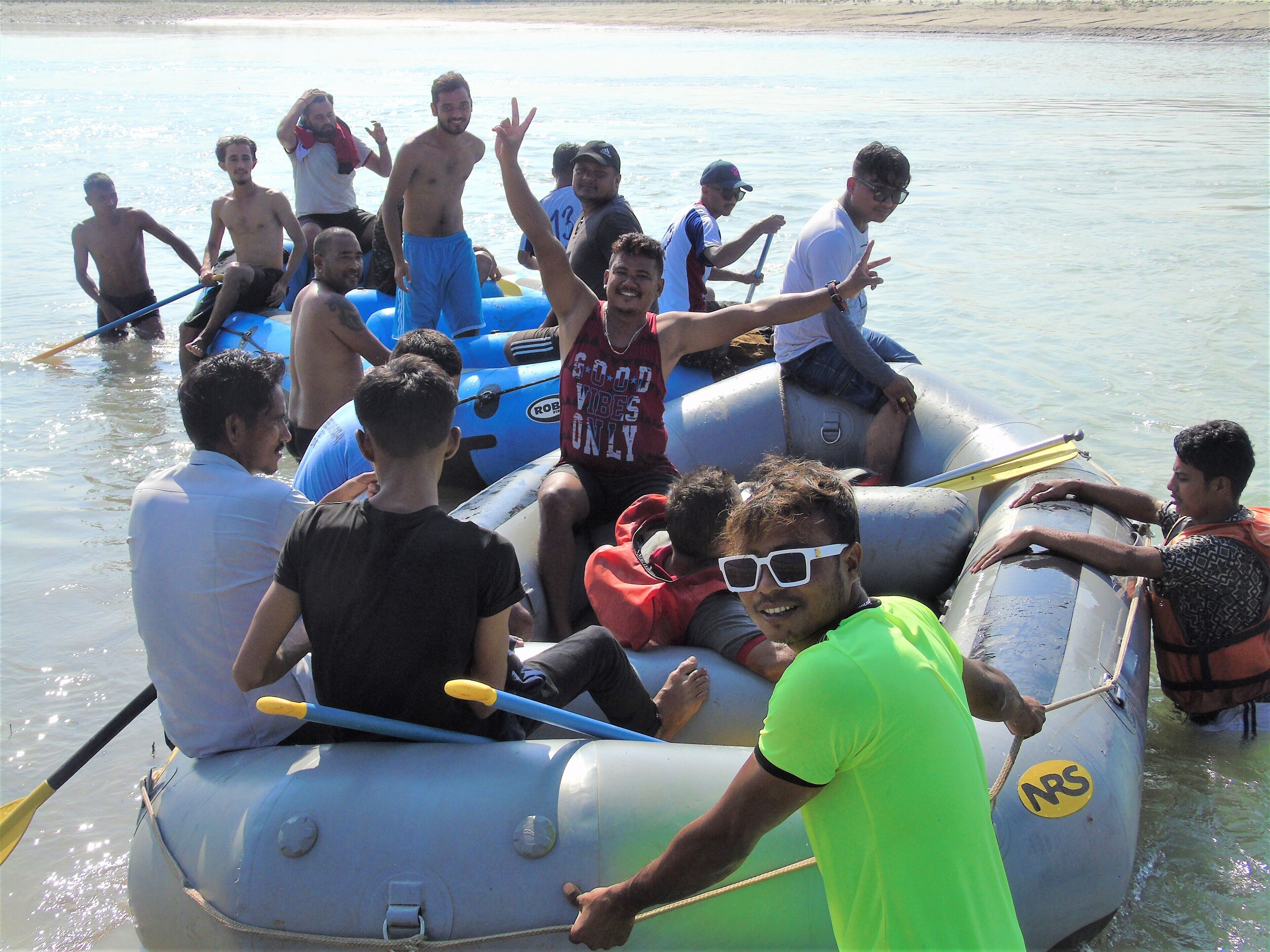 A group of people on a raft in a body of water.