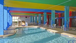 An indoor swimming pool with multiple lanes, surrounded by colorful pillars and a blue ceiling. - Amazing Oceanfront 1 Bedroom (Myrtle Beach)