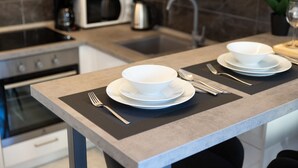 A modern kitchen with a grey countertop, a microwave, a coffee maker, and a sink. - Apartment Isola with terrace and parking (Rovinj)