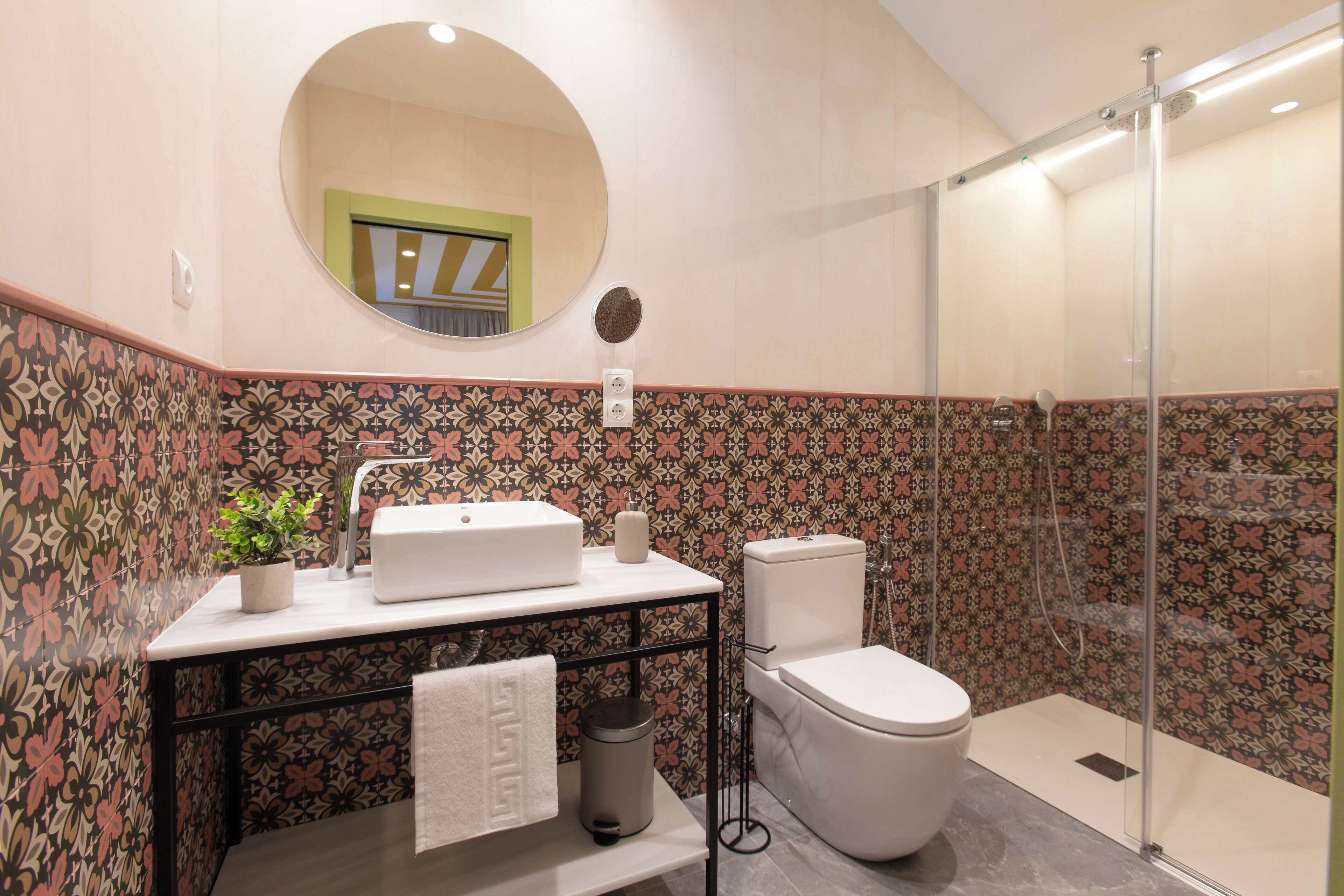 A bathroom with a toilet, sink, and shower.