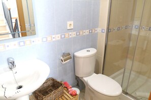 Un baño con lavabo, inodoro y ducha.