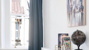 Una habitació amb un taulell blanc, un globus i un llibre a sobre.