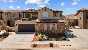 A residential area with houses featuring red-tiled roofs and stucco walls. - Double The Fun 7 Bedroom Home (Ivins)