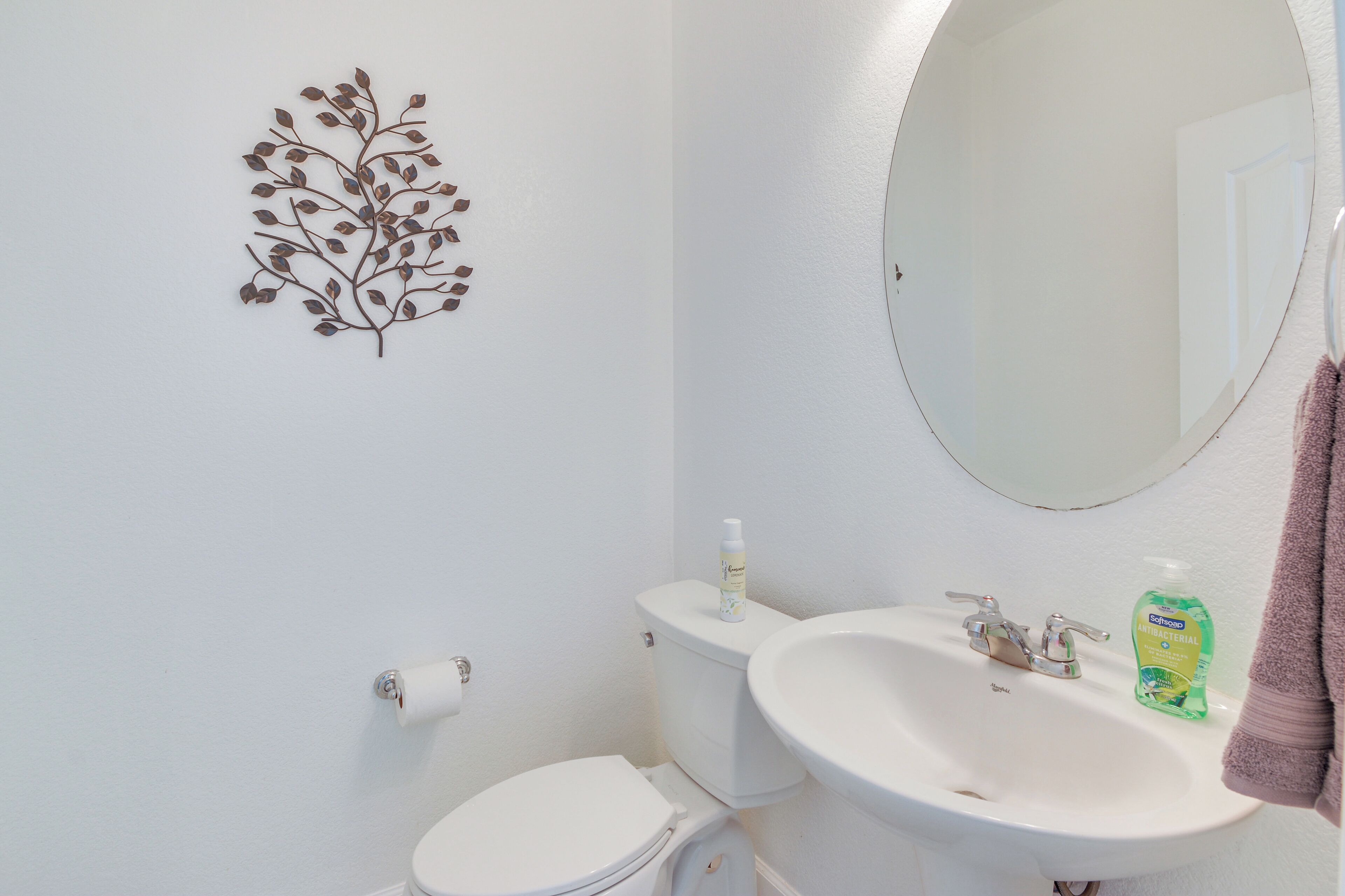 Un baño con inodoro, lavabo y espejo.