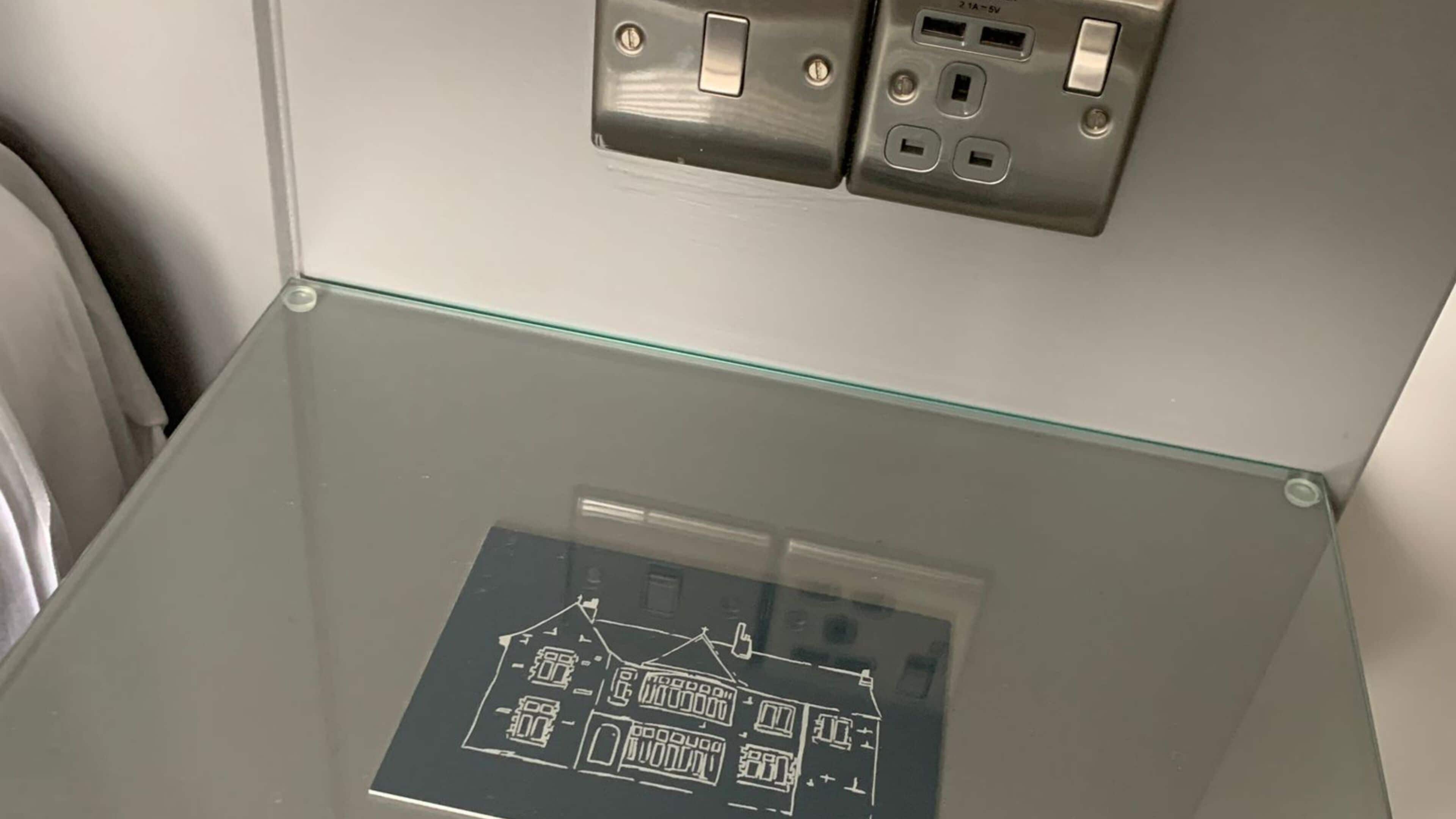 A glass table with a printed map of a building layout.