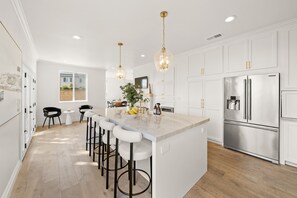 Enjoy cooking in this well-lit kitchen with a central island and bar stools.