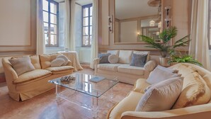 A spacious living room with two beige sofas, a glass coffee table, and a large mirror. - Miranda s Home in Varenna (Varenna)