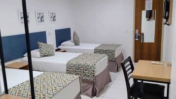 Economy Triple Room | Minibar, in-room safe, laptop workspace, blackout drapes