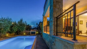 A stone building with a swimming pool, outdoor seating, and a stone wall. - Holiday house EMY with pool in Krk 600m from the beach (Krk)