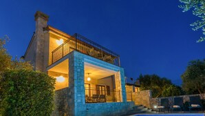A two-story house with a swimming pool, stone exterior, and outdoor seating area. - Holiday house EMY with pool in Krk 600m from the beach (Krk)