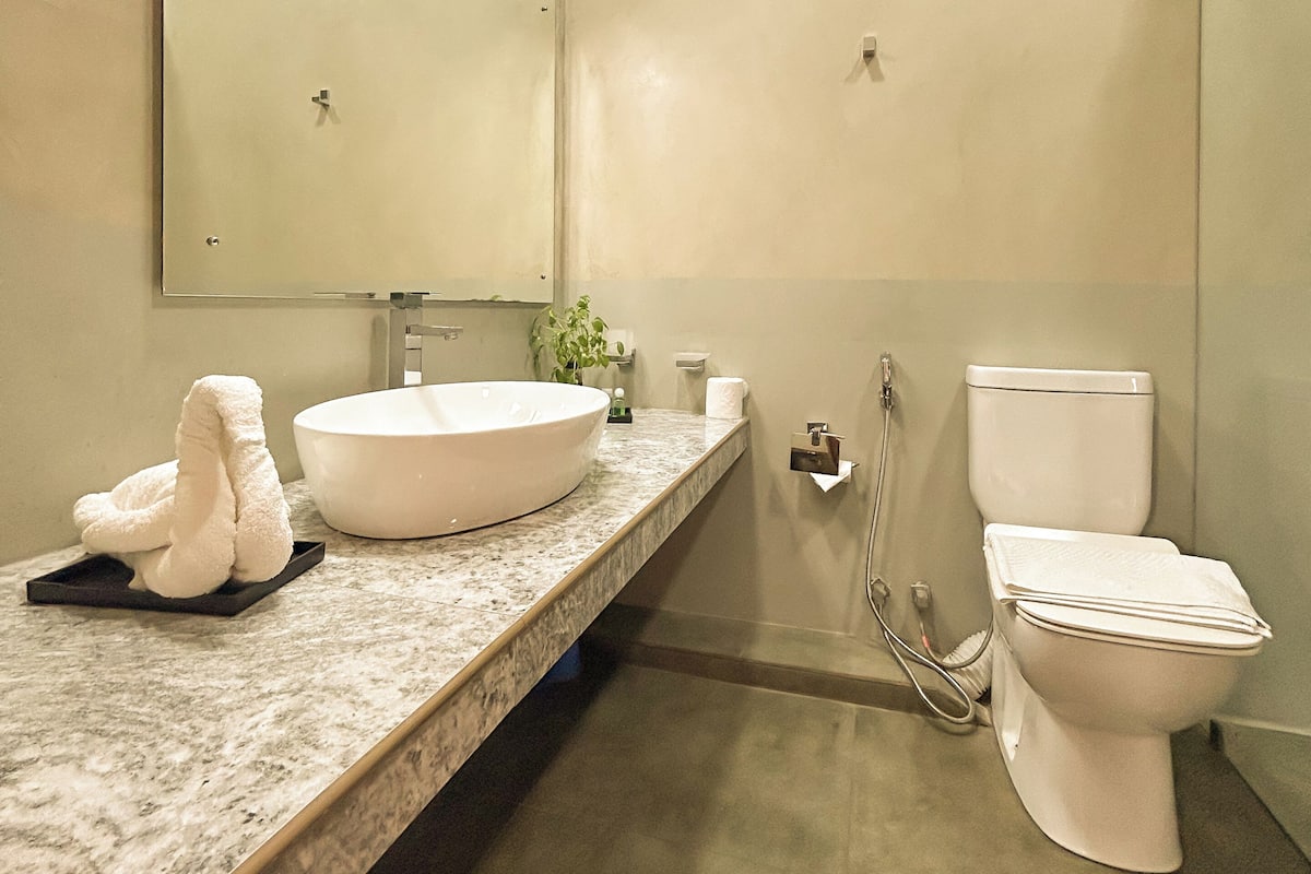 Ein modernes Badezimmer mit Waschbecken, Toilette und Spiegel.
