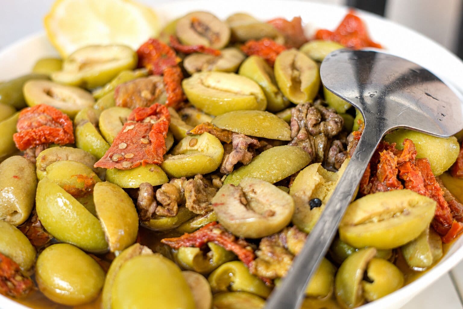 A dish with olives, mushrooms, and sun-dried tomatoes.