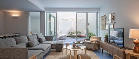 Signature Apartment | Living area | 43-inch Smart TV with satellite channels