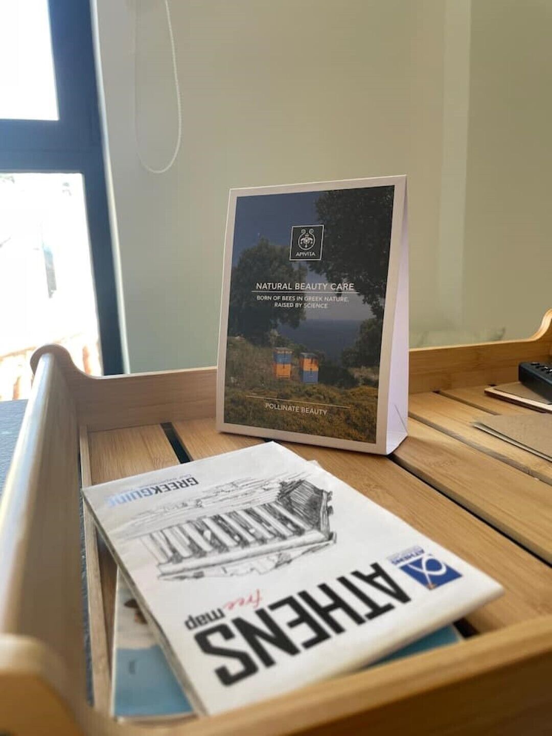 A wooden desk with a book titled "Natural Beauty Care" and a box with a similar theme.