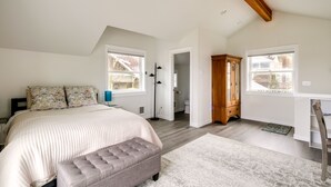 A bedroom with a large bed, a wooden wardrobe, and a desk with a chair. - Port Orchard Guest House - Walk to Bay Street! (Port Orchard)
