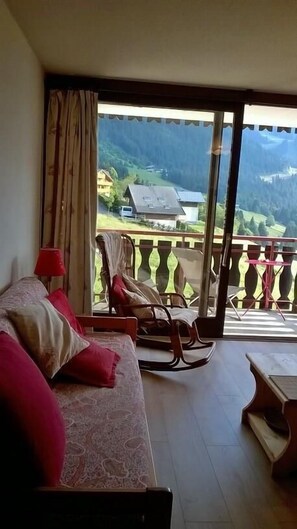 Enjoy a mountain view from the balcony with a glass door leading to an outdoor space.