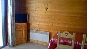 Cozy retreat with a cabinet, radiator, and comfortable bed.
