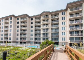 Residents enjoy balconies and access to a communal pool area.