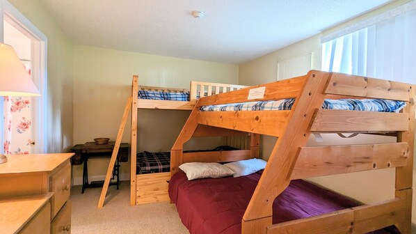 A bunk bed room with a desk and a lamp. - Village at Winnipesaukee Unit 111 (Laconia)