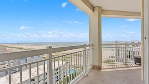 A balcony with a view of the beach and ocean. - Oceanfront 3BR Residence with Wraparound Veranda (Wildwood)