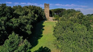 A medieval tower surrounded by dense greenery. - Beautiful private villa for 4 guests with A/C, WIFI, private pool and TV (La Giustiniana)