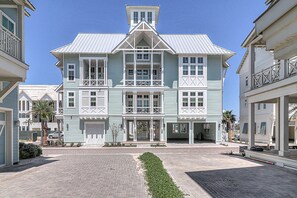 A large, multi-story building with a central entrance, balconies, and a symmetrical facade. - Shell Yeah! 320 COA (Port Aransas)
