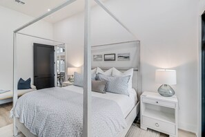 Cozy retreat with a four-poster bed, bedside table, and nightstand.