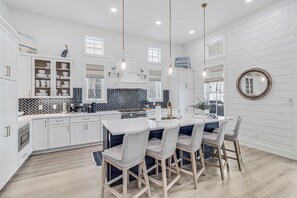 Enjoy cooking in this well-equipped kitchen with a central island and bar stools.