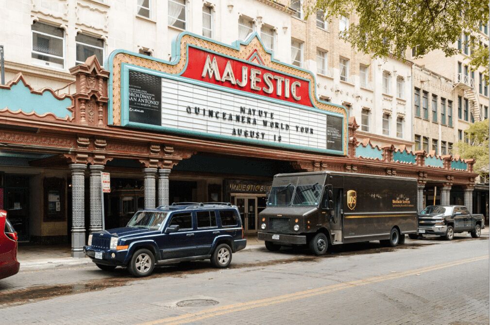A theater marquee with "MAJESTIC" and "NATURAL WORLD TOUR" advertising.