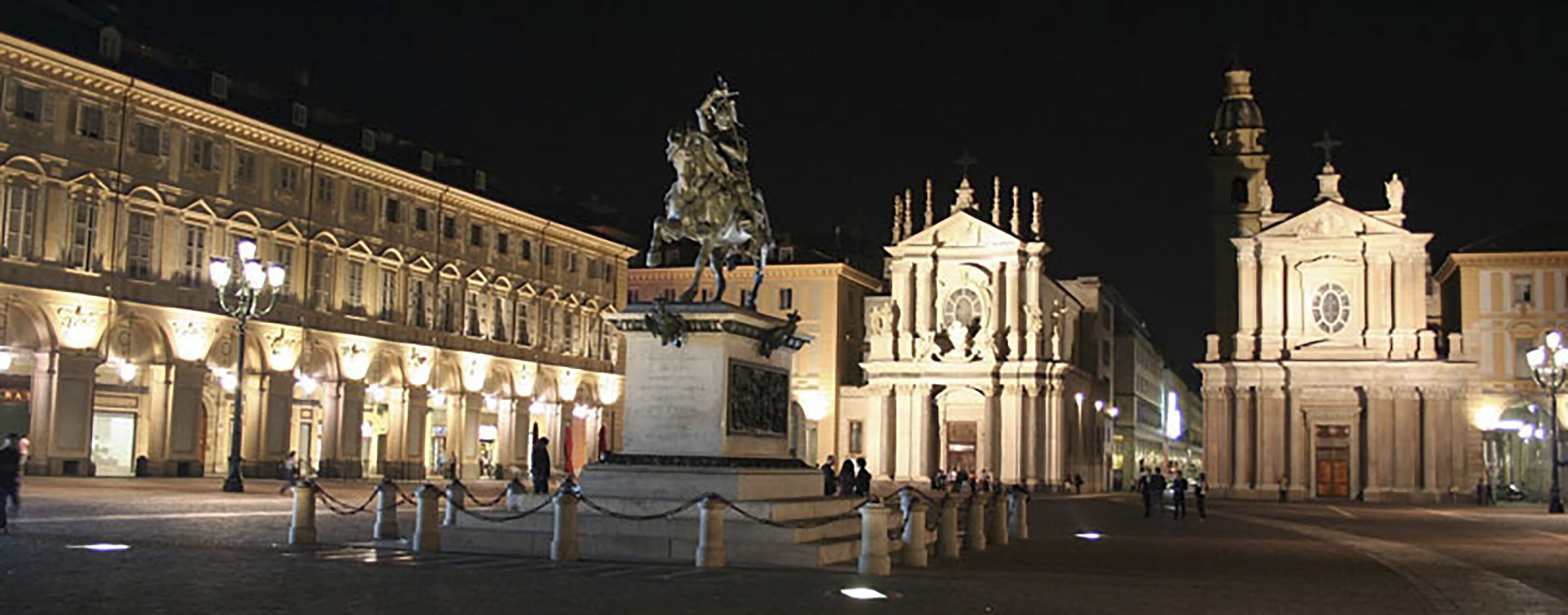 A historic square with a statue, a church, and classical architecture.