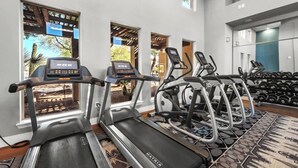 A gym with treadmills, elliptical machines, and weight benches. - Chic 1-Bedroom Pet-Friendly, Near Sunrise Peak (Scottsdale)