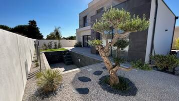Stylish two-story residence with a minimalist design, featuring a well-maintained garden and clean lines.